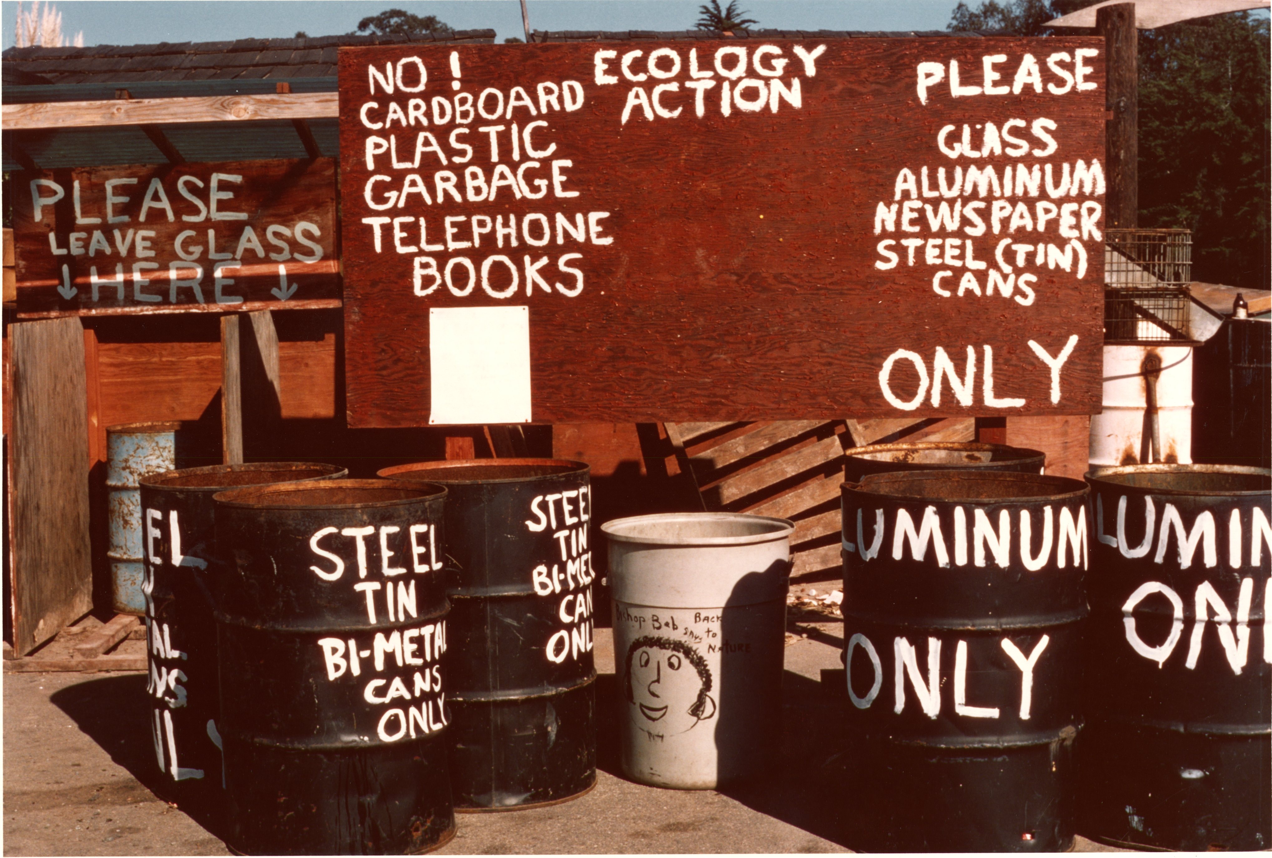 Marion Post Wolcott, "Entrance of Ecology Center," 1975. Photograph of hand-painted recycling barrels in front of the center.