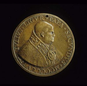 Bust of Julius II facing right, tonsured, wearing cope with incised ornament and panelled orphrey (figures of Saints &c.) and morse (Virgin and Child). Pearled border.